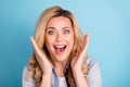 Close up photo of cheerful excited woman shouting yelling opening mouth isolated over blue background Royalty Free Stock Photo