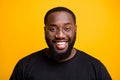 Close up photo of cheerful positive attractive black man with whitened teeth looking at you with smile on face isolated