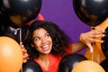 Close up photo of cheerful stylish cute nice pretty girlfriend hiding among air balls expressing positive emotions of Royalty Free Stock Photo