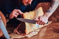 Close-up photo of a chef cook cutting exclusive jerky meat on table in a kitchen with loft interior. Royalty Free Stock Photo