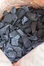 Close-up photo of coal in the paper bag
