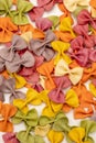 Close-up Photo of colorful Italian pasta background. Traditional Italian food, joyful and Various colors of bow tie farfalle pasta Royalty Free Stock Photo