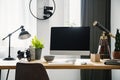 Close-up photo of computer with mockup standing on a wooden desk