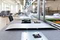 Close-up photo of a conveyor belt at a monoblock computer assembly plant. Modern high-tech factory