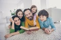 Close up photo cozy positive people family dad daddy read tell story mom mommy preteen children listen small girl point