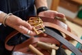 close-up photo of crafstman comparing leather belts during work Royalty Free Stock Photo