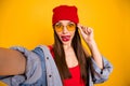 Close up photo of cute trendy teen make faces grimacing touch eyewear eyeglasses isolated over yellow background Royalty Free Stock Photo
