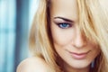 Close up photo of cute young adult blonde woman with blue eyes. Royalty Free Stock Photo