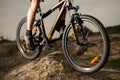 Close up Photo of Cyclist Riding Bike Down the Rock. Extreme Sport and Enduro Biking Concept.