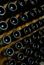 Close up photo of dark bottles of wine laying underground, winery autumn concept