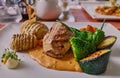 Close up photo of a delicious gourmet meal of pork, fancy potato, broccoli, zucchini at a traditional German Hotel Restaurant Royalty Free Stock Photo