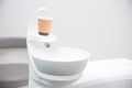 Close up photo of dentistry sink with a paper cup on it ready for mouth wash. Royalty Free Stock Photo