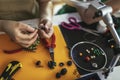 Close up photo designer making handmade jewelry in studio workshop.