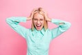 Close up photo of disappointed manager yelling touching her head wearing mint-colored shirt isolated over pink Royalty Free Stock Photo