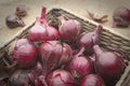 Close up of red onions in a basket Royalty Free Stock Photo