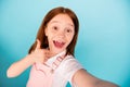 Close up photo excited charming kid make photo video call laugh wear overalls isolated over blue background