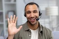 Close-up photo. Face portrait of a smiling young African American man at home wearing a headset talking and greeting the Royalty Free Stock Photo