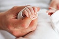 Close up photo of father holding newborn baby hand. Royalty Free Stock Photo