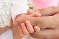 Close Up Photo Of Father`s Hand Holding His Newborn Baby Girl Hand