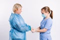 Close-up photo of a female caregiver and senior woman patient holding hands. Senior care concept. Young female doctor Royalty Free Stock Photo