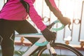 Close up Photo of Female Cyclist Hands in Gloves on Road Bicycle Handlebar in Cold Sunny Autumn Day. Healthy Lifestyle. Royalty Free Stock Photo