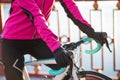 Close up Photo of Female Cyclist Hands in Gloves on Road Bicycle Handlebar in Cold Sunny Autumn Day. Healthy Lifestyle. Royalty Free Stock Photo