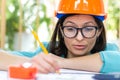 Close up photo of female engineer wearing orange helmet. Royalty Free Stock Photo