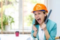 Close up photo of female engineer wearing orange helmet. Royalty Free Stock Photo