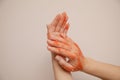 Close-up photo, female hands apply peeling pink scrub. Skin care. Healthy hand skin concept