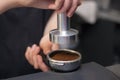 barista preparing for pressing ground coffee for brewing espresso or americano in a cafe Royalty Free Stock Photo