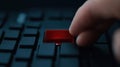 Close up photo of finger poised to press large red delete key. Action of removing data. User pressing key conveys urgency,
