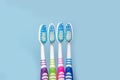 Photo of four multi-colored toothbrush, blue background with copy space, top view. The concept of healthy teeth in the Royalty Free Stock Photo