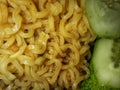 close-up photo of fried noodles and cucumber