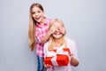 Close up photo friendly blond hair she her grandma small granddaughter hide eyes do not look hold large big giftbox wear