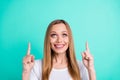 Close up photo of funky youth looking up advertising adverts isolated over teal turquoise background