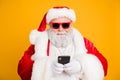 Close up photo of funny cool overweight santa claus in red hat headwear using smartphone search winter season tradition Royalty Free Stock Photo
