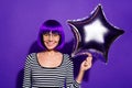 Close up photo of funny youth holding hand baloon look stare isolated over purple violet background