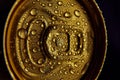 Close-up photo of golden aluminum closed can, jar of beer, coke, soda with condensation water drops against black Royalty Free Stock Photo