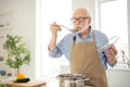 Close up photo grey haired he his him grandpa appetite waiting guests cooking favorite family dish trying taste wait Royalty Free Stock Photo