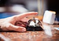 Close up photo of hand ringing a hotel reception service bell Royalty Free Stock Photo