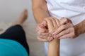 Professional massage therapist working on a woman hand and foot Royalty Free Stock Photo