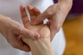 Professional massage therapist working on a woman hand and foot Royalty Free Stock Photo