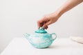 Close up photo of handmade blue teapot at pottery studio isolated Royalty Free Stock Photo