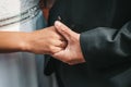 Close-up photo of the hands of the bride and groom, decorated with wedding rings. The beauty of their intertwined fingers. Rings Royalty Free Stock Photo