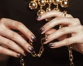 Close up photo hands with gold manicure holding