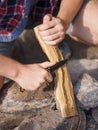 Boys hands start fire with magnesium fire steel, fire striker. Royalty Free Stock Photo