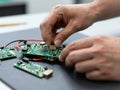 Close-up of Hands Sorting Clean E-Waste Components on Work Mat Royalty Free Stock Photo