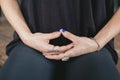 hands of a woman yogi meditating in kneeling pose in her vinyasa flow yoga practice alone