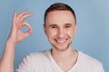 Close up photo of handsome guy showing okay alright perfect great sign isolated blue color background