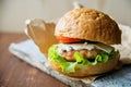 Close-up photo of home made hamburger with beef, onion, tomato, lettuce, cheese and spices. Fresh burger closeup on Royalty Free Stock Photo